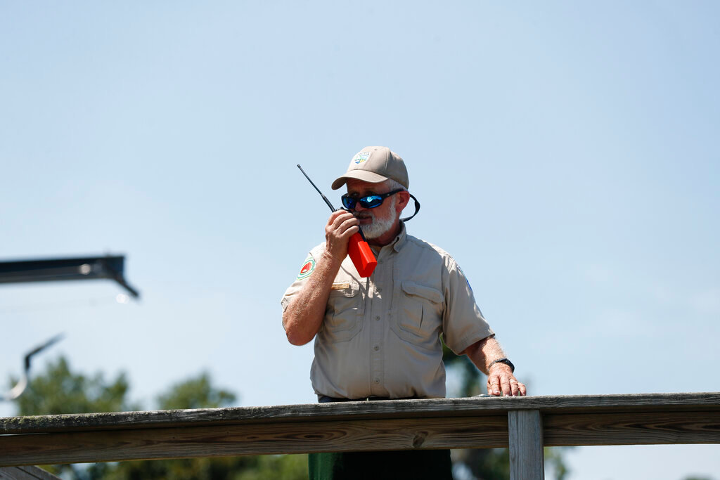 Byron Haire, area fire management officer for area 8 of the Georgia Forestry Commission, radios his crew from the dock at St. Catherine's Island on Wednesday June 22, 2022. (Richard Burkhart/Savannah Morning News via AP)