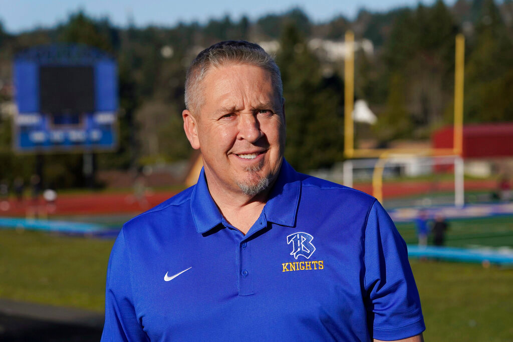 Joe Kennedy, a former assistant football coach at Bremerton High School in Bremerton, Wash., poses for a photo on March 9, 2022 at the school’s football field. (AP Photo/Ted S. Warren, File)