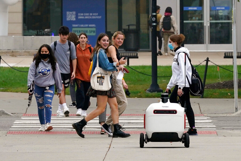 A food delivery robot crosses a street in Ann Arbor, Mich. on Oct. 7, 2021. (AP Photo/Carlos Osorio)