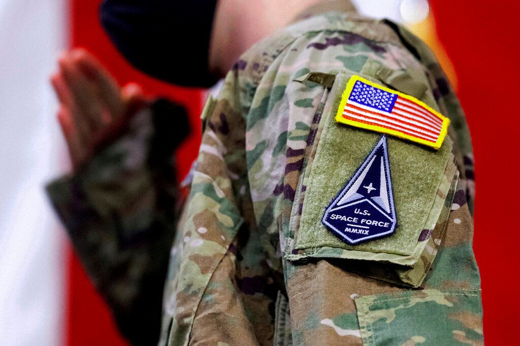An Air Force specialist with a U.S. Space Force patch salutes during a ceremony for U.S. Air Force airmen transitioning to U.S. Space Force Guardian designations Feb. 12, 2021, at Travis Air Force Base, Calif. (AP Photo/Noah Berger, File)