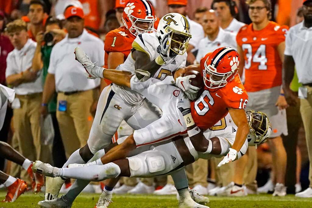 Clemson wide receiver E.J. Williams is brought down by Georgia Tech' Ayinde Eley and Tariq Carpenter after a reception in an NCAA football game Sept. 18, 2021, in Clemson, S.C. (AP Photo/John Bazemore, File)