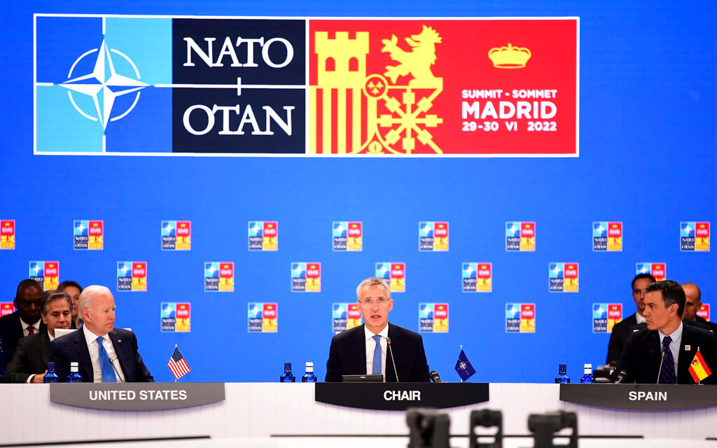 NATO Secretary General Jens Stoltenberg center, flanked by Spanish Prime Minister Pedro Sanchez, right, and U.S President Joe Biden open the first plenary session of the NATO summit in Madrid, Wednesday, June 29, 2022. (Bertrand Guay, Pool via AP)