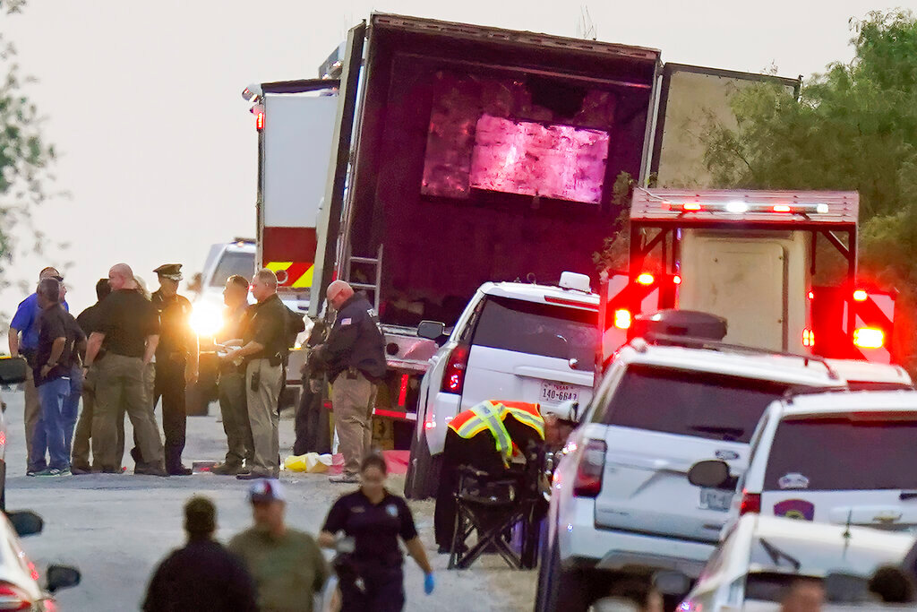 Police and other first responders work the scene where officials say dozens of people have been found dead and multiple others were taken to hospitals with heat-related illnesses after a semitrailer containing suspected migrants was found Monday, June 27, 2022, in San Antonio. (AP Photo/Eric Gay)
