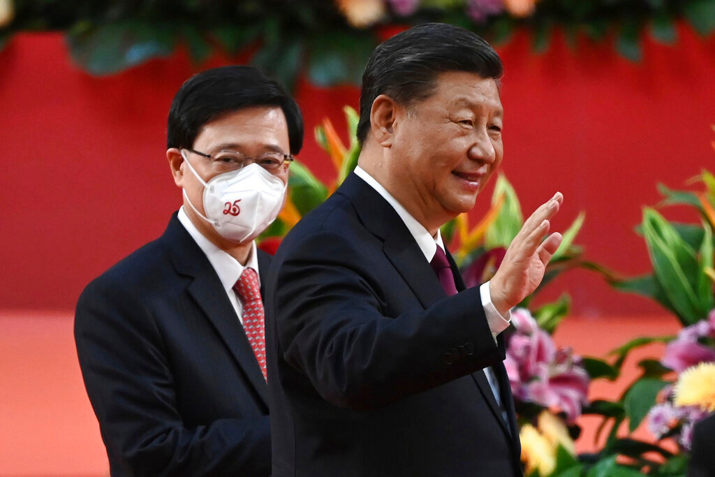 Hong Kong's new Chief Executive John Lee, left, walks with China's President Xi Jinping after a ceremony to inaugurate the city's new leader and government in Hong Kong Friday, July 1, 2022, on the 25th anniversary of the city's handover from Britain to China. (Selim Chtayti/Pool Photo via AP)