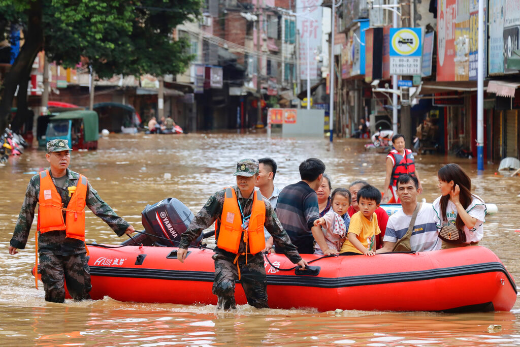 Rescuers evacuate stranded residents in flood water in Tuojiang Township, Jianghua Yao Autonomous County, Yongzhou in central China's Hunan Province, June 22, 2022. (Jiang Linfeng/Xinhua via AP, File)