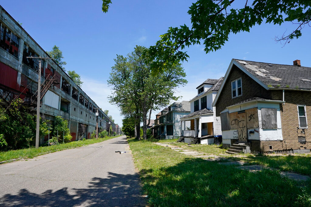 The Packard Plant, left, sits across the street from boarded-up houses on Detroit's east side, June 30, 2022. (AP Photo/Carlos Osorio)