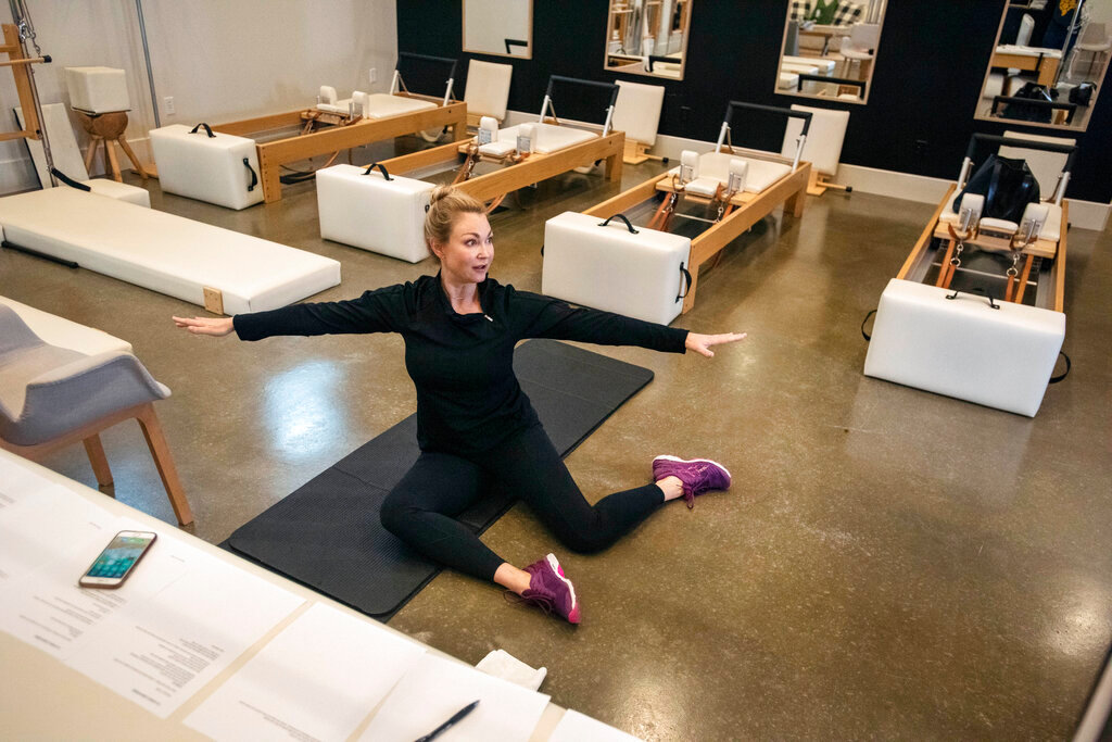 Sarah Burton, owner of Studio B Pilates + Barre leads a Zoom-based live dance conditioning class at her studio in Tyler, Texas, April 4, 2020. (Sarah A. Miller/Tyler Morning Telegraph via AP, File)