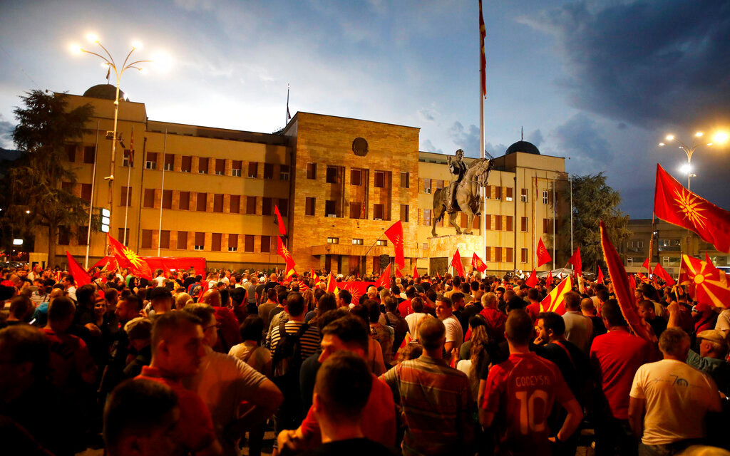 Protesters gather in front of the parliament building in Skopje, North Macedonia, late Tuesday, July 5, 2022. (AP Photo/Boris Grdanoski)