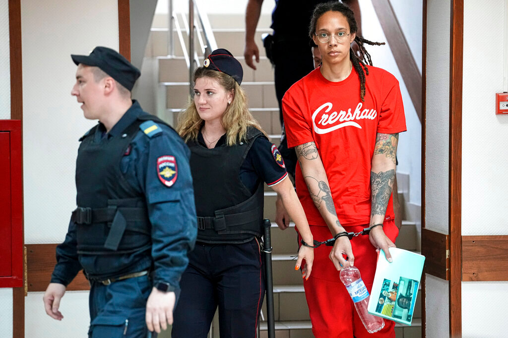 WNBA star and two-time Olympic gold medalist Brittney Griner is escorted to a courtroom for a hearing, in Khimki just outside Moscow, Russia, Thursday, July 7, 2022. (AP Photo/Alexander Zemlianichenko)