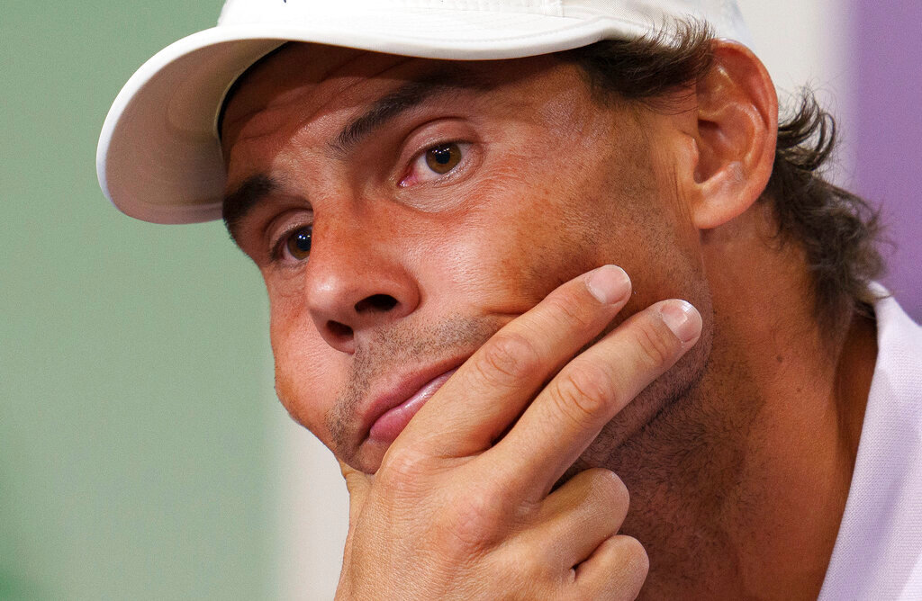 Spain’s Rafael Nadal announces that he is withdrawing from the men’s singles semifinal match at the Wimbledon tennis championships, in London, Thursday, July 7, 2022. (Joe Toth/Pool Photo via AP)
