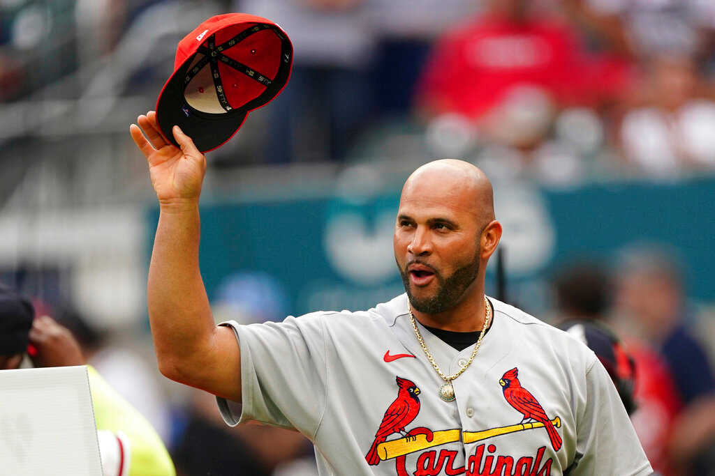 St. Louis Cardinals' Albert Pujols tips this cap to the crowd as he is honored before the team's game against the Atlanta Braves on Thursday, July 7, 2022, in Atlanta. (AP Photo/John Bazemore)