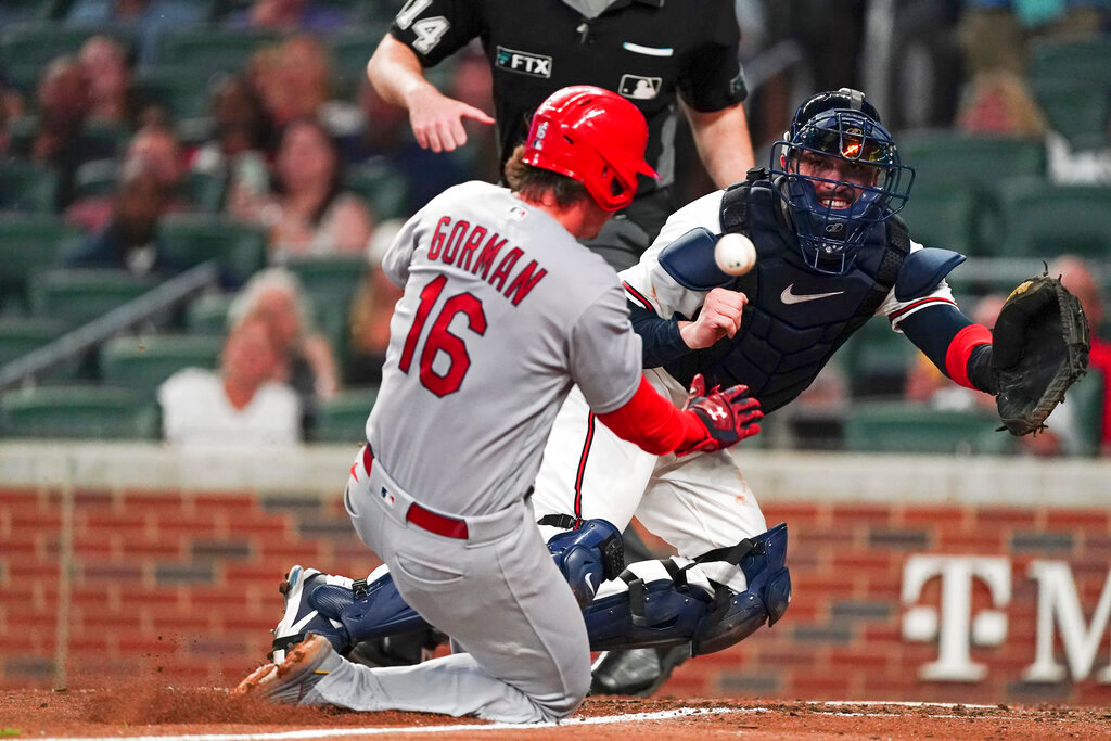 St. Louis Cardinals' Nolan Gorman (16) scores ahead of the throw to Atlanta Braves catcher Travis d'Arnaud (16), on a sacrifice fly by Albert Pujols, in the seventh inning Thursday, July 7, 2022, in Atlanta. (AP Photo/John Bazemore)