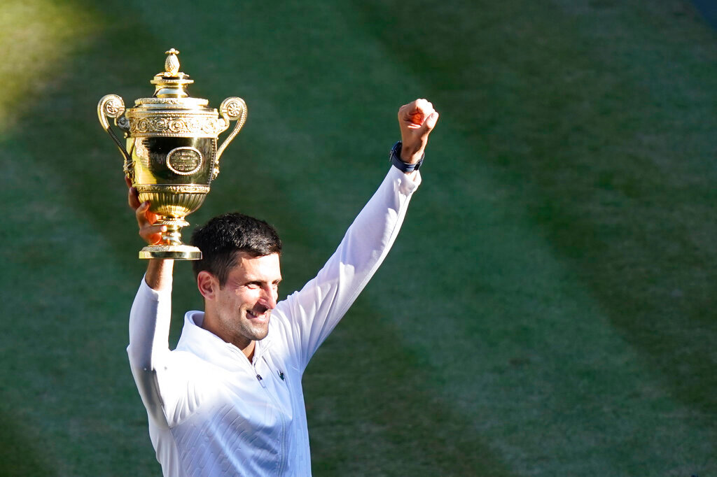 Serbia's Novak Djokovic holds the winners trophy as he celebrates after beating Australia's Nick Kyrgios to win the final of the men's singles at the Wimbledon tennis championships in London, Sunday, July 10, 2022. (AP Photo/Gerald Herbert)