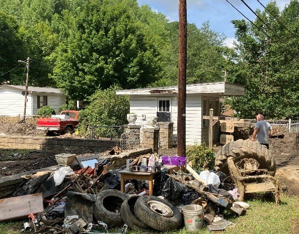 Residents of Jenkins, Ky. deal with an assortment of flood debris, including old tires. (Georgia Baptist Disaster Relief/Chris Fuller)