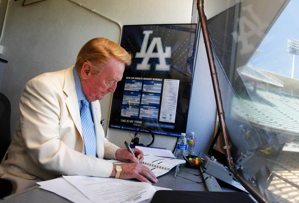 Vin Scully works in his booth at Dodger Stadium in Los Angeles on Aug. 22, 2010. (AP Photo/Jae C. Hong, File)