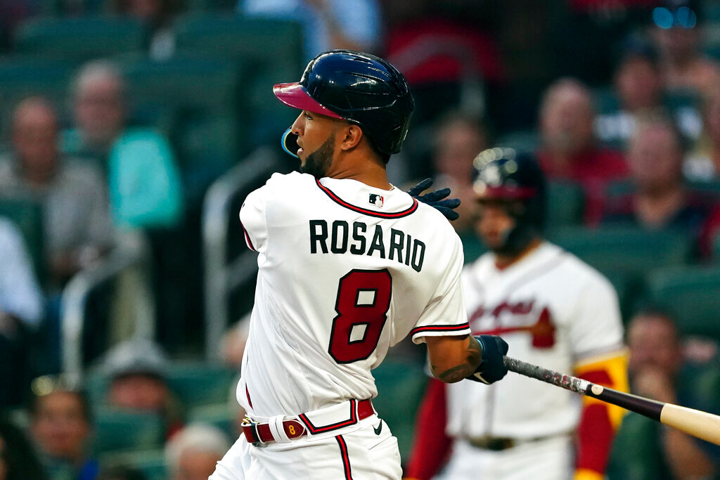 Atlanta Braves' Eddie Rosario follows through on a two-run base hit in the third inning against the Philadelphia Phillies Tuesday, Aug. 2, 2022, in Atlanta. (AP Photo/John Bazemore)
