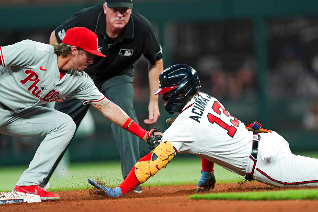 Atlanta Braves' Ronald Acuna Jr. (13) is tagged out at second base by Philadelphia Phillies second baseman Bryson Stott (5) as he tries to stretch a single in the fourth inning Tuesday, Aug. 2, 2022, in Atlanta. (AP Photo/John Bazemore)