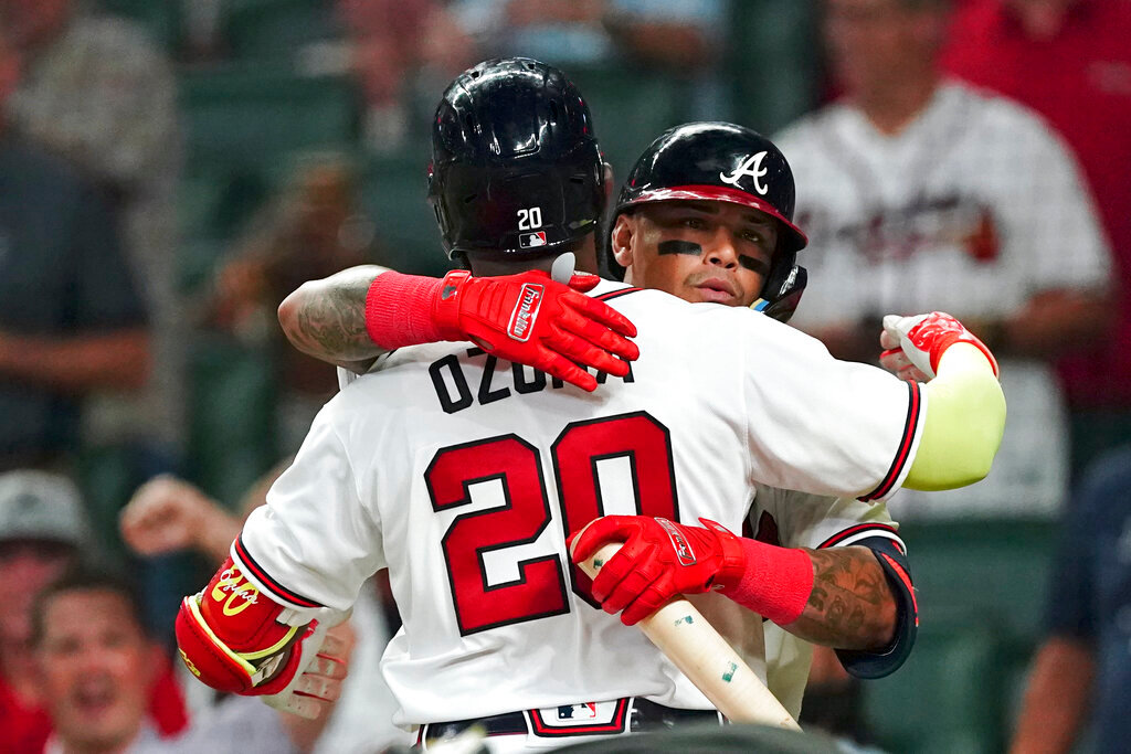 Atlanta Braves' Marcell Ozuna (20) is greeted at home plate by Orlando Arcia (11) after hitting a home run in the seventh inning against the Philadelphia Phillies Tuesday, Aug. 2, 2022, in Atlanta. (AP Photo/John Bazemore)