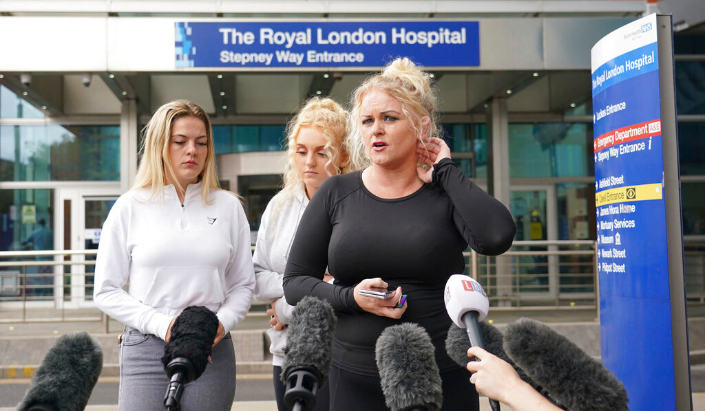 Hollie Dance, right, the mother of Archie Battersbee, speaks to the media outside the Royal London hospital, Wednesday, Aug. 3, 2022. Archie Battersbee's family says it has appealed to the European Court of Human Rights in a last-ditch bid to stop a hospital from ending his treatment. (Dominic Lipinski/PA via AP)