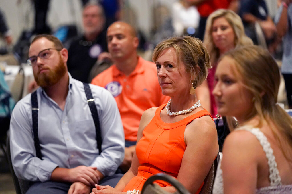 People listen as organizers speak during a Value Them Both watch party Tuesday, Aug. 2, 2022, in Overland Park, Kan. (AP Photo/Charlie Riedel)