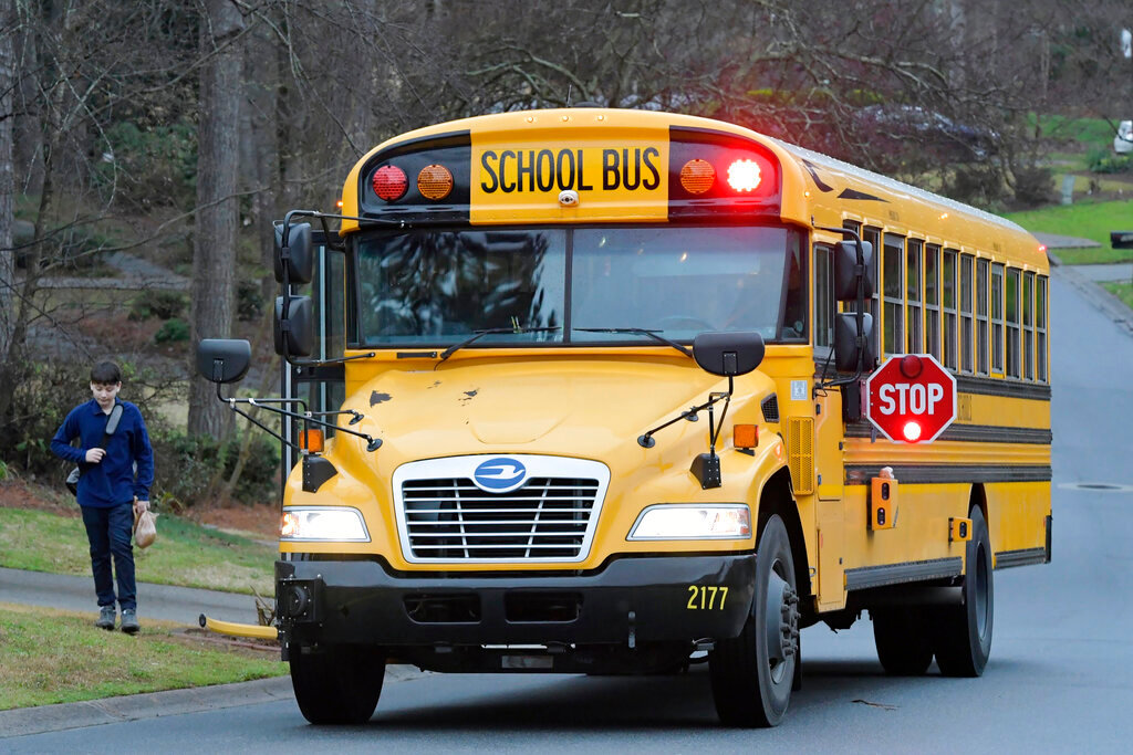 A Cobb County School bus is seen March 13, 2020, in Kennesaw, Ga. (AP Photo/Mike Stewart, File)