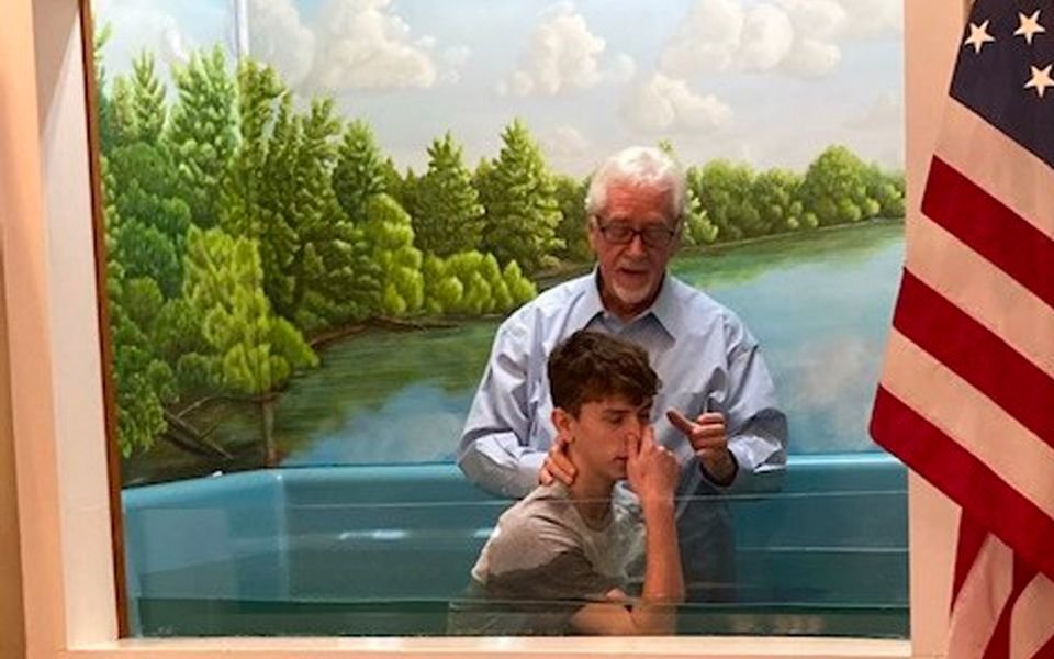 Pastor Joe Aguillard baptizes 15-year-old Kyler Emfinger at Kelly Baptist Church. (Submitted photo)