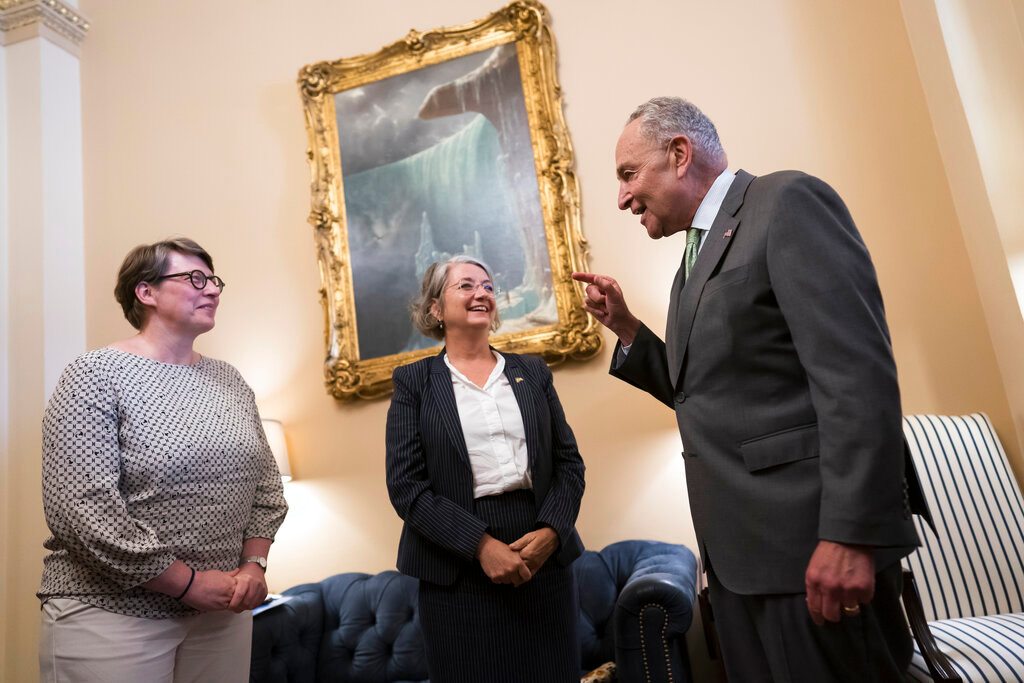 Senate Majority Leader Chuck Schumer, D-N.Y., right, welcomes Paivi Nevala, minister counselor of the Finnish Embassy, left, and Karin Olofsdotter, Sweden's ambassador to the U.S., center, just before the Senate vote to ratify NATO membership for the two nations at the Capitol in Washington, Wednesday, Aug. 3, 2022. (AP Photo/J. Scott Applewhite)