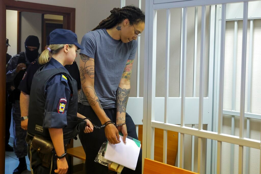 WNBA star and two-time Olympic gold medalist Brittney Griner, right, enters a cage in a courtroom prior to a hearing in Khimki just outside Moscow, Thursday, Aug. 4, 2022. (Evgenia Novozhenina/Pool Photo via AP)