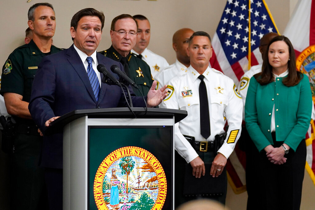 Florida Gov. Ron DeSantis, surrounded by members of law enforcement, speaks during a news conference Thursday, Aug. 4, 2022, in Tampa, Fla. (AP Photo/Chris O'Meara)