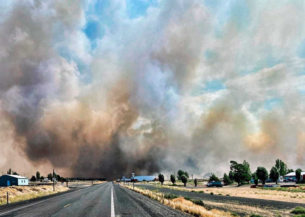 Smoke from a wildfire burning south of Lind, Wash., rises Thursday, Aug. 4, 2022. (Washington State Department of Transportation via AP)