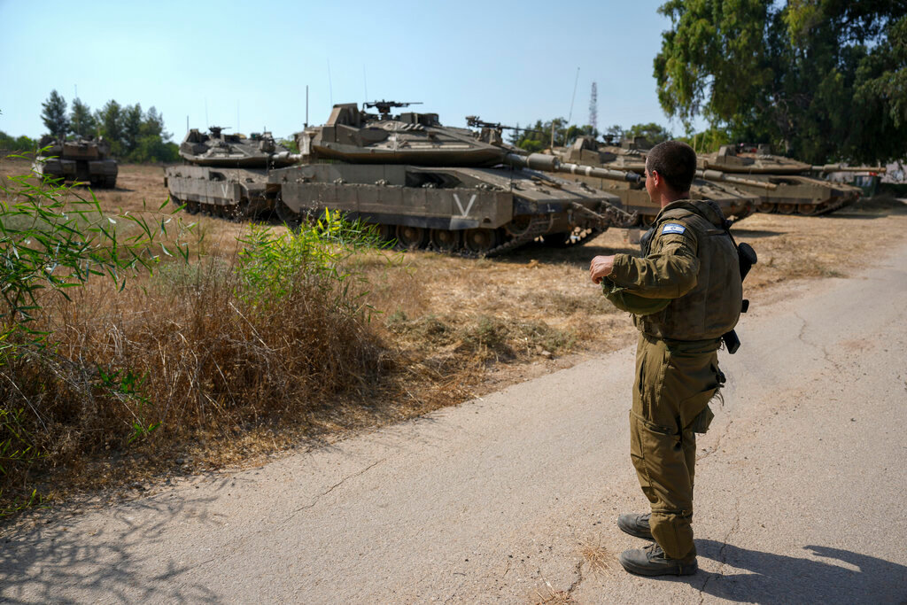An Israeli soldier secures tanks in an area near the border with Gaza Strip, Friday, Aug. 5, 2022. (AP Photo/Ariel Schalit)
