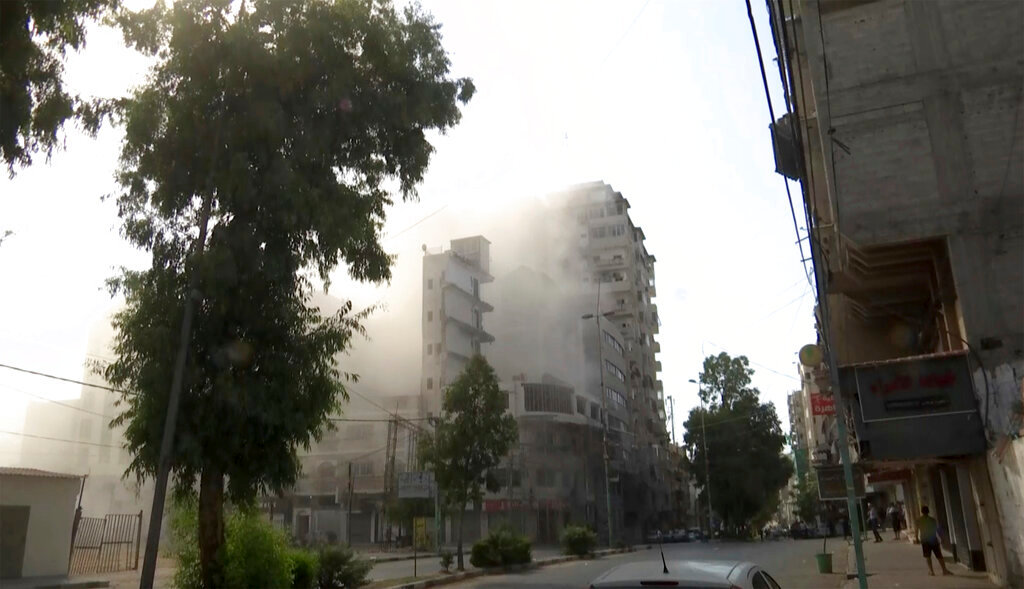 Smoke pours out of a tall building after an Israeli airstrike in Gaza City on Friday, Aug. 5, 2022. (AP Photo)