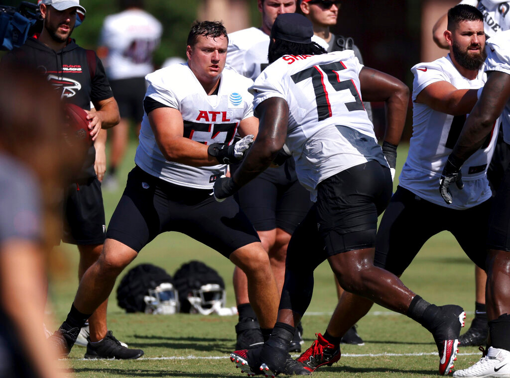Atlanta Falcons offensive guard Chris Lindstrom (63) and offensive guard Justin Shaffer (75) participate in a drill during NFL football training camp in Flowery Branch, Ga., July 29, 2022. (Jason Getz/Atlanta Journal-Constitution via AP)