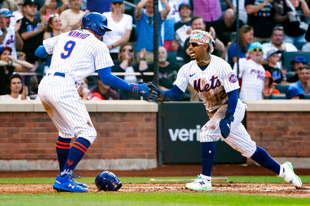 New York Mets' Brandon Nimmo and Francisco Lindor celebrate after scoring during the third inning against the Atlanta Braves, Sunday, Aug. 7, 2022, in New York. (AP Photo/Julia Nikhinson)