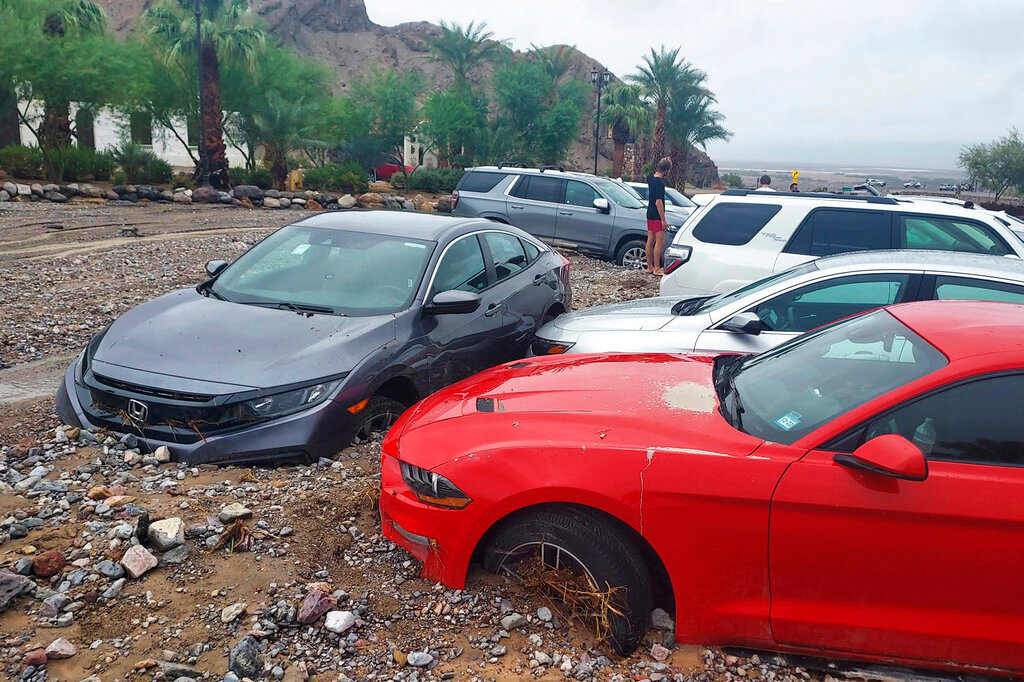 Cars are stuck in mud and debris from flash flooding at The Inn at Death Valley in Death Valley National Park, Calif., Friday, Aug. 5, 2022. (National Park Service via AP)