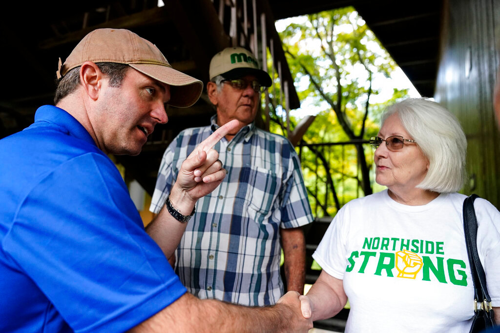 Kentucky Governor Andy Beshear, left, talks with residents that have been displaced by floodwaters at Jenny Wiley State Resort Park Saturday, Aug. 6, 2022, in Prestonsburg, Ky. (AP Photo/Brynn Anderson)