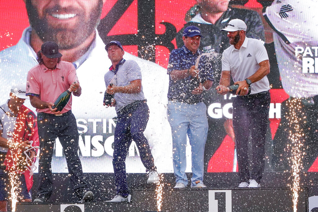 The "4 Aces" team celebrates with champagne after winning the team competition during a ceremony after the final round of the Bedminster Invitational LIV Golf tournament in Bedminster, N.J., July 31, 2022. From left to right, Pat Perez, Talor Gooch, Patrick Reed and Dustin Johnson. (AP Photo/Seth Wenig)