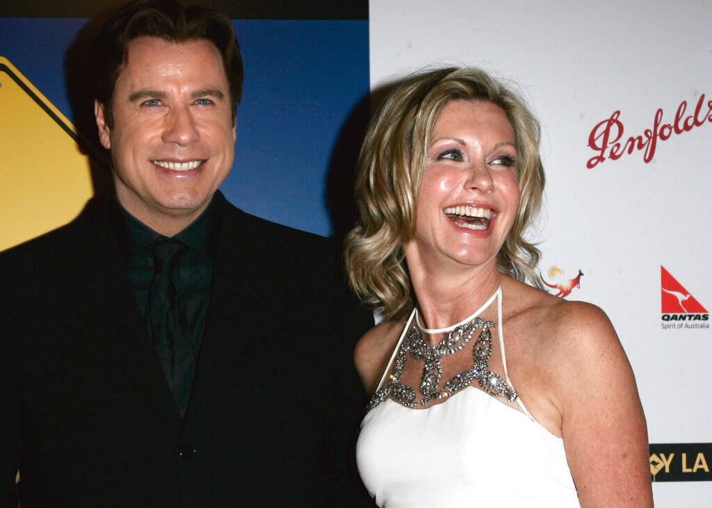 John Travolta, left, and Olivia Newton-John arrive at The Penfolds Icon Gala Dinner in Los Angeles on Jan. 14, 2006. (AP Photo/Branimir Kvartuc, File)