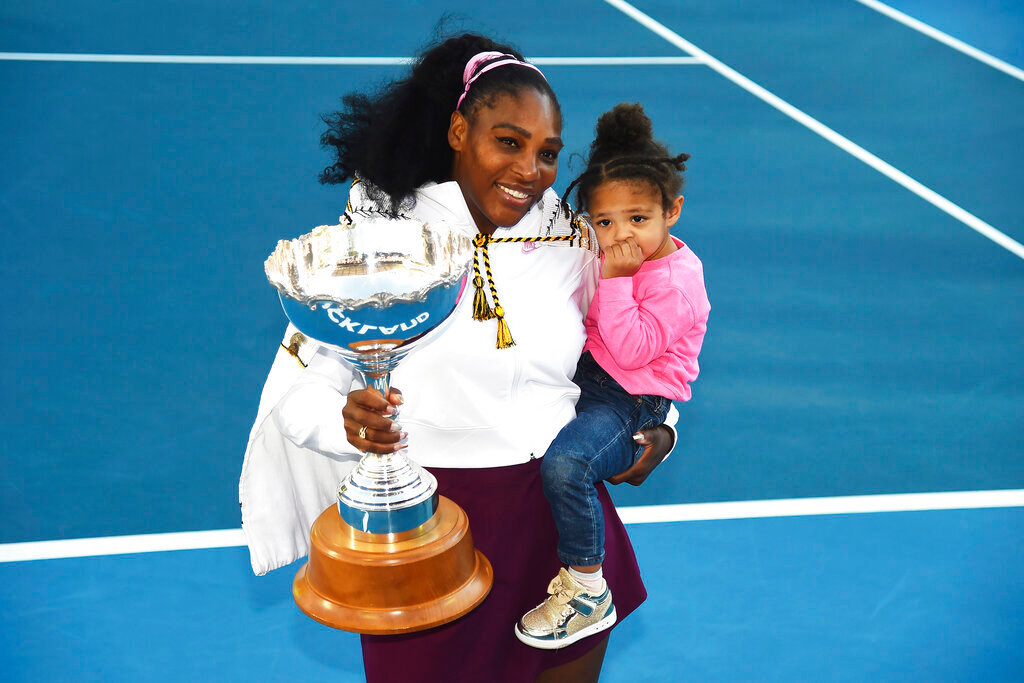 Serena Williams holds her daughter Alexis Olympia Ohanian Jr., and the ASB trophy after winning her singles finals match against Jessica Pegula at the ASB Classic in Auckland, New Zealand, Jan 12, 2020. (Chris Symes/Photosport via AP, File)