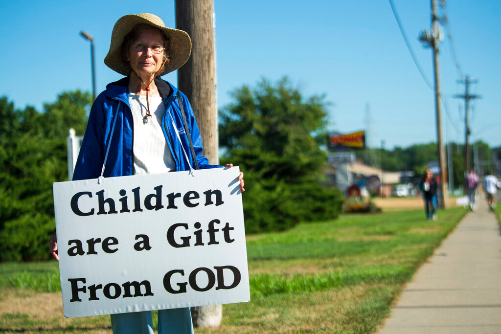 A pro-life demonstrator stands outside of the Planned Parenthood Clinic for morning prayers on Tuesday, Aug. 9, 2022, in Lincoln, Neb. (Kenneth Ferreira/Lincoln Journal Star via AP)