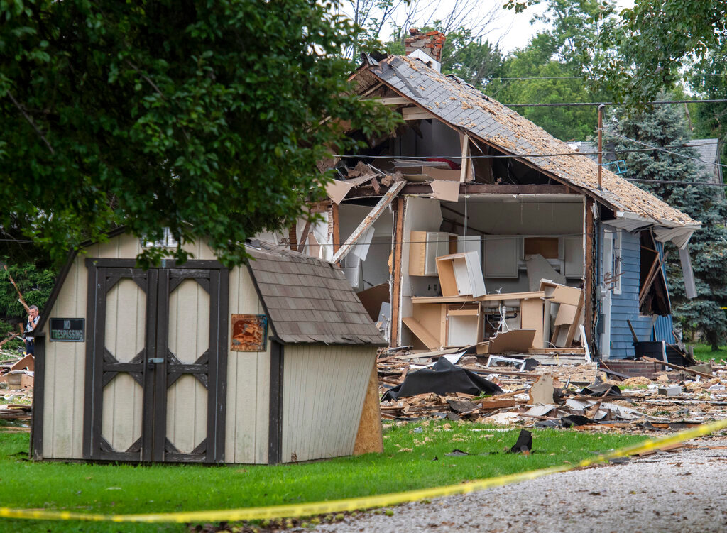 Emergency crews respond to a house explosion in Evansville, Ind., Wednesday afternoon, Aug. 10, 2022. (MaCabe Brown/Evansville Courier & Press via AP)