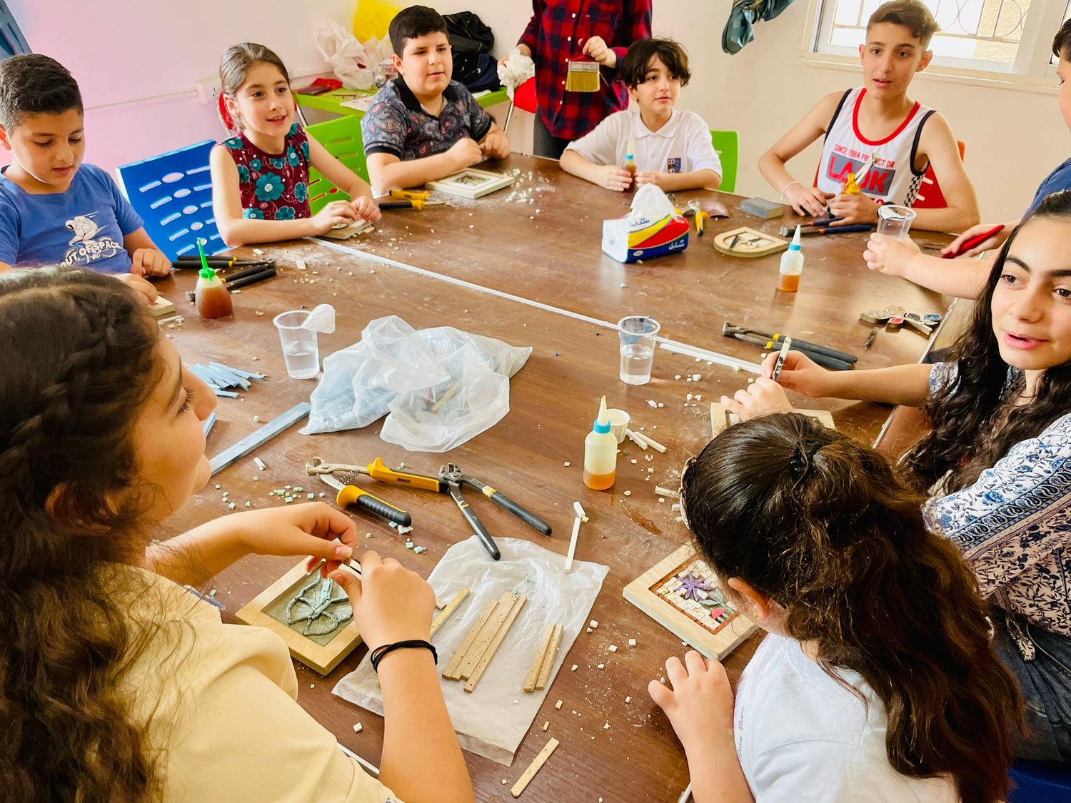 Children of Iraqi Christian refugees craft mosaic artwork at The Olive Tree Center, a Christian cultural and economic center in Madaba, Jordan, helping refugees of the 2014 ISIS invasion of Iraq. (Submitted photo)
