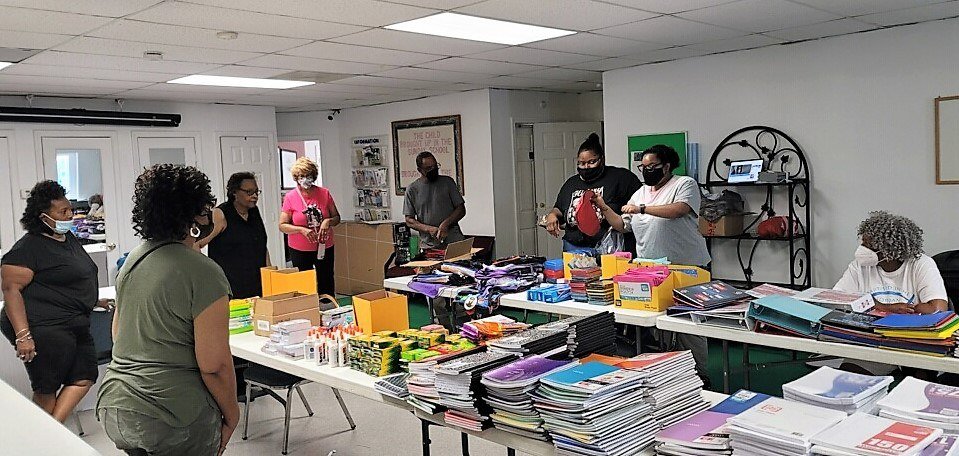 Members of The Favor Church in Decatur, Ga., distribute school supplies for about 200 backpacks given away at the church’s two back-to-school outreaches. (Submitted photo)