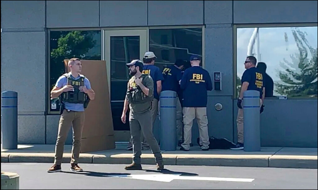 FBI officials gather outside the FBI building in Cincinnati, Thursday, Aug. 11, 2022, after an armed man tried to breach a security screening area. (FOX19 Cincinnati via AP)
