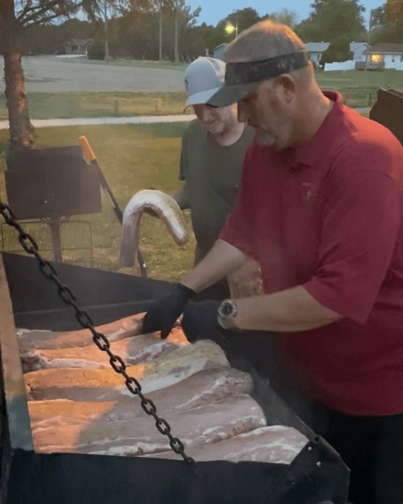 Ian Harp, right, smokes 300 pounds of pork tenderloin at summer outreach event for Huran Baptist Church in Huron, S.D. The church registered 523 people at the event and discovered 126 prospects. Three people gave their life to Christ, said Harp, the church’s pastor.