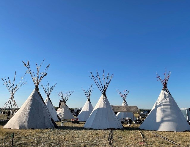 Teepees erected by a mission team from Jonesboro First Baptist Church stand in contrast to a brilliant blue sky in Montana.