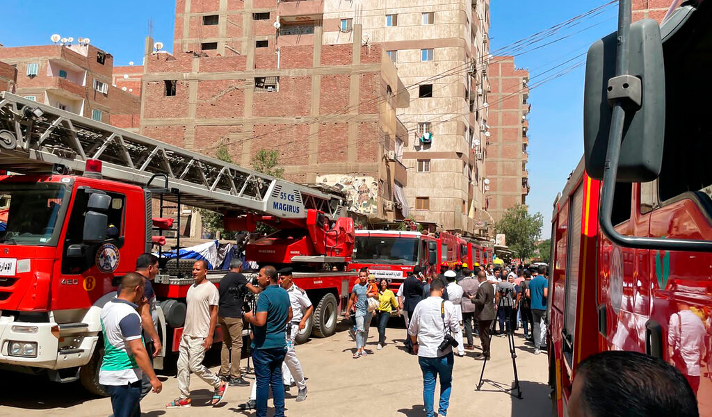 Emergency personnel work at the site of a fire at the Abu Sefein church in the densely populated neighborhood of Imbaba, Cairo Egypt, Sunday, Aug. 14, 2022. (AP Photo/Mohamed Salah)
