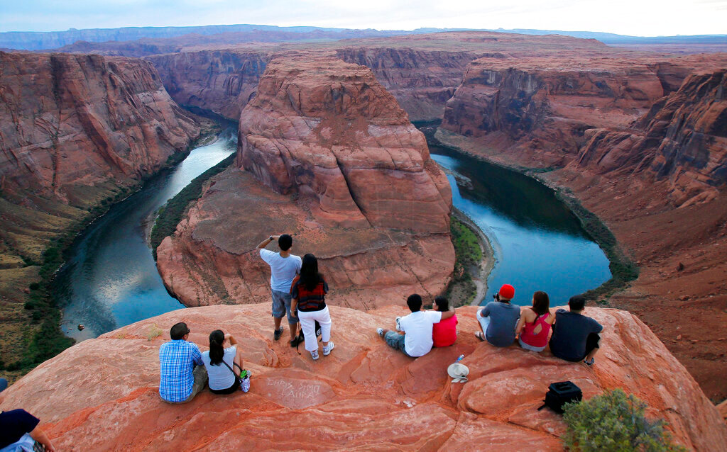Visitors view the dramatic bend in the Colorado River at the popular Horseshoe Bend in Glen Canyon National Recreation Area, in Page, Ariz., on Sept. 9, 2011. (AP Photo/Ross D. Franklin, File)