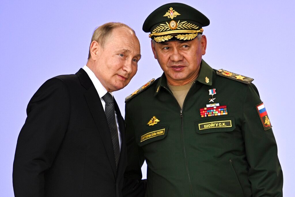 Russian President Vladimir Putin and Defense Minister Sergei Shoigu, right, attend the opening of the Army 2022 International Military and Technical Forum outside Moscow, Russia, Monday, Aug. 15, 2022. (Sputnik, Kremlin Pool Photo via AP)