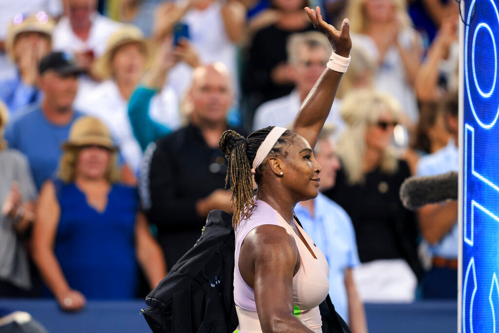 Serena Williams waves to the crowd after losing 6-4, 6-0 to Emma Raducanu, of Britain, during the Western & Southern Open tennis tournament Tuesday, Aug. 16, 2022, in Mason, Ohio. (AP Photo/Aaron Doster)